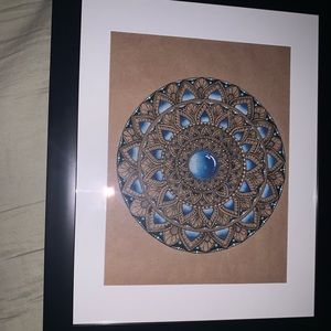 Blue and white mandala drawing with black frame
